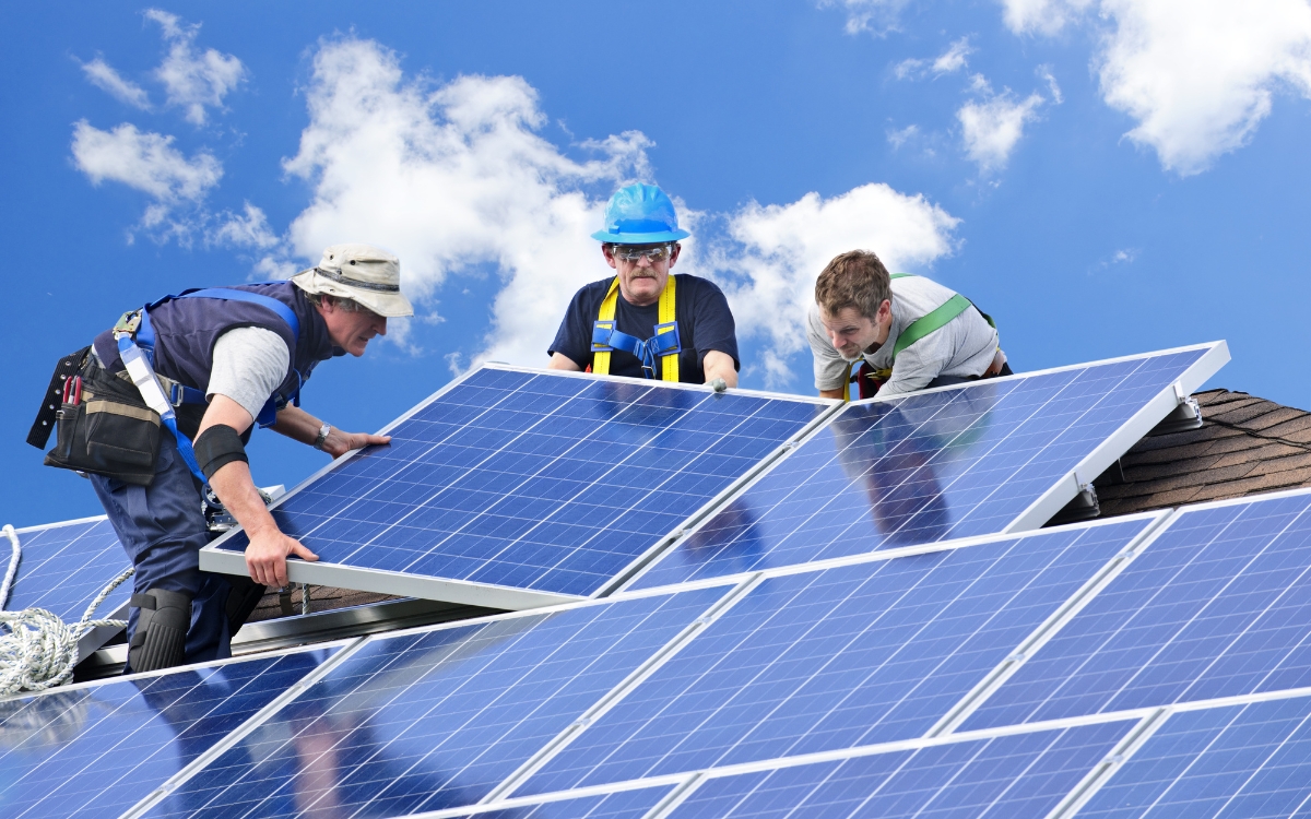 men working on a solar panel