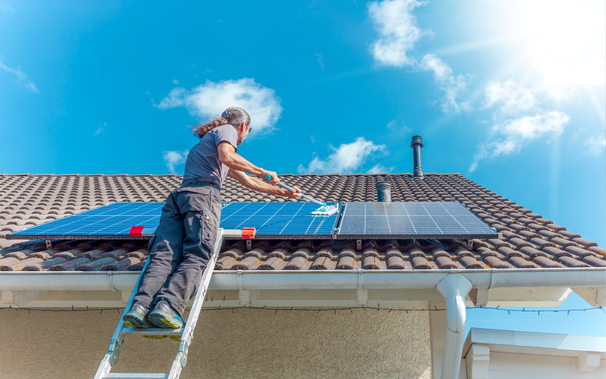 a man on a ladder on a roof